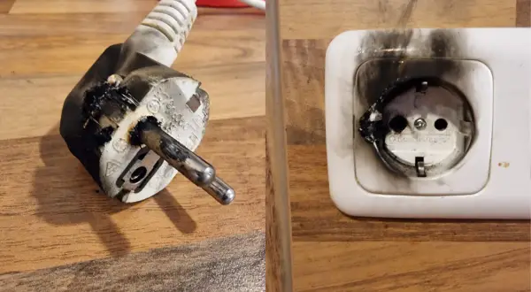 Verkohltes Stecker und Steckdose nach Kurzschluss. Wasserkocher Brandgefahr!